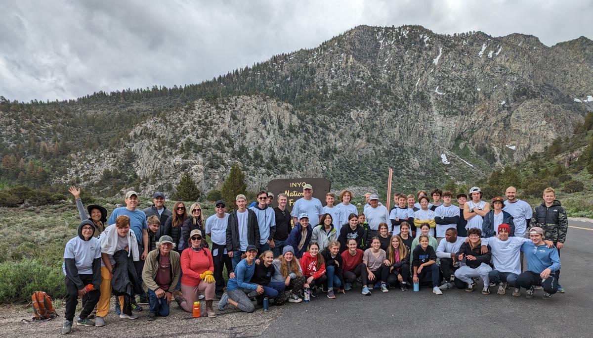 Mono County Recreation, Inyo National Forest, June Lake Trails Committee and an LA Church group volunteer project Image of a large group of adult and youth volunteers posing for a group picture in front of a mountain backdrop.